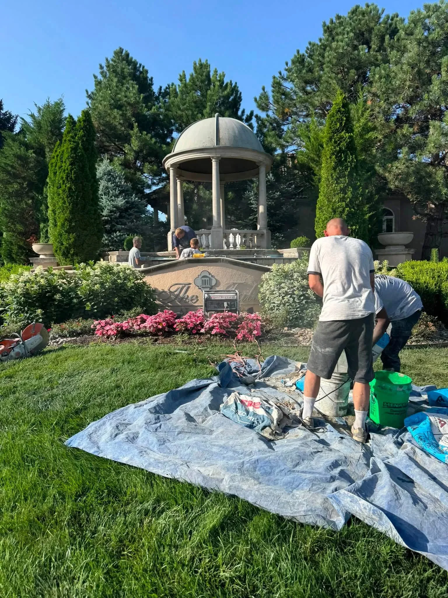 Dome gazebo roof restoration with protective tarping and landscaping preservation